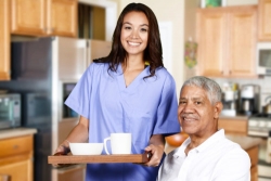 caregiver serving food to a senior