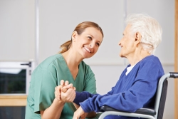 caregiver and senior woman smiling